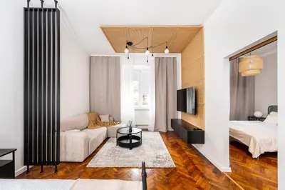 a living room with a bed and a couch at Słowackiego 43 Apartament in Kraków