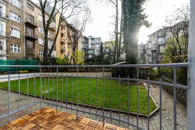 a park in the middle of a city with buildings at Słowackiego 43 Apartament in Kraków