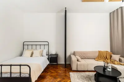a bedroom with a bed and a couch at Słowackiego 43 Apartament in Kraków