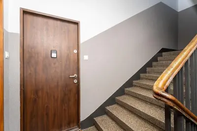 a living room with a bed and a table at Mogilska Standard Apartment by BookingHost in Kraków