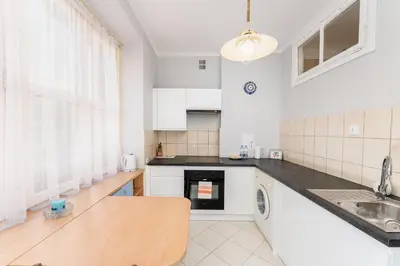a living room with a couch and a table at Mogilska Standard Apartment by BookingHost in Kraków