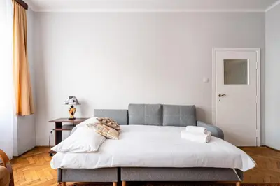 a living room with a couch and a table at Mogilska Standard Apartment by BookingHost in Kraków
