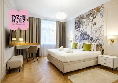 a bedroom with a large white bed and a desk at Wenecja by Tyzenhauz in Kraków