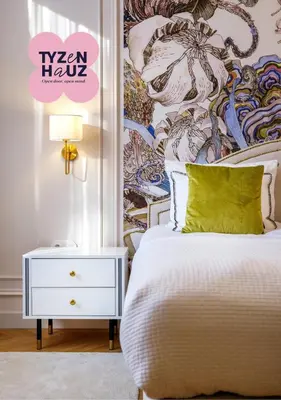 a bedroom with a white bed with a green pillow at Wenecja by Tyzenhauz in Kraków