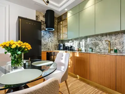 a kitchen with a glass table and white chairs at Wenecja by Tyzenhauz in Kraków