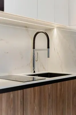 a kitchen counter with a sink in a kitchen at Eleganckie Studio Royal w sercu Krakowa in Kraków