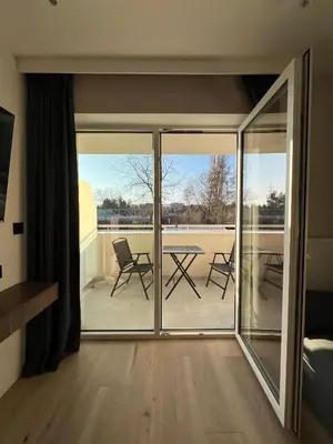 a room with a glass door with a table and chairs at Eleganckie Studio Royal w sercu Krakowa in Kraków