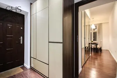 a hallway with a sliding door and a dining room at Przytulny apartament w sercu Krakowa Old Town in Kraków