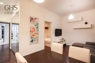 a living room with a couch and a table and chairs at Przytulny apartament w sercu Krakowa Old Town in Kraków