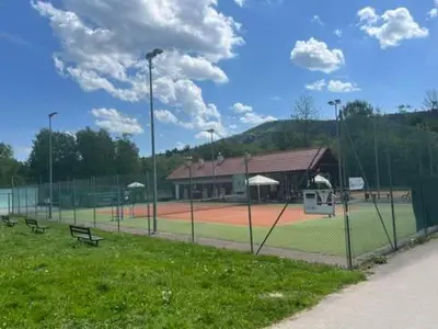 a baseball field with benches and a basketball hoop at Chata pod lasem z balią i sauną in Myślenice
