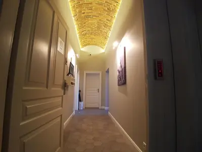 a hallway with a ceiling with a light at Apartamenty Czapskich in Kraków