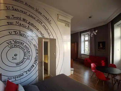 a room with a wall with a drawing on the wall at Apartamenty Czapskich in Kraków