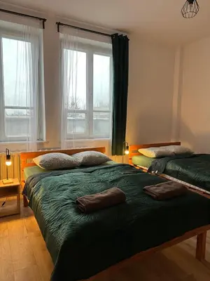 a bedroom with two beds and a window at New KiKo in Kraków