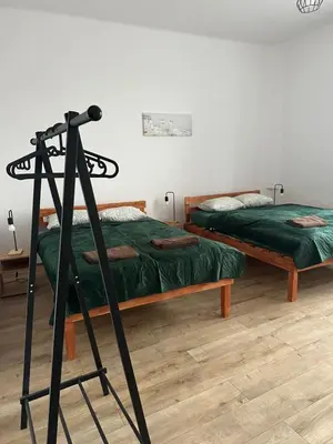 a room with two beds and a tripod at New KiKo in Kraków