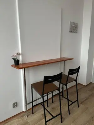 a desk with two chairs and a table with a plant at New KiKo in Kraków