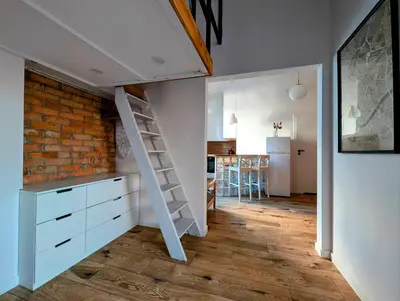 a room with a loft bed and a brick wall at Dąbrowskiego 15 by Homeprime in Kraków