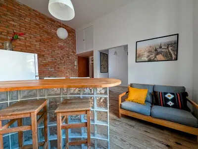 a living room with a table and a couch at Dąbrowskiego 15 by Homeprime in Kraków