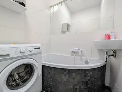 a laundry room with a washing machine and a sink at Dąbrowskiego 15 by Homeprime in Kraków