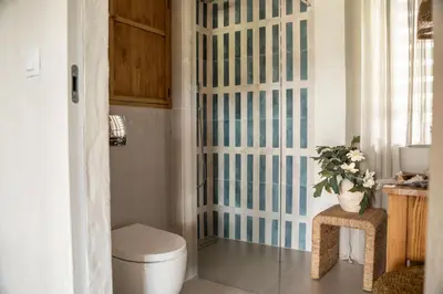 a bathroom with a toilet and a glass shower stall at Mucharskie Wzgórze in Mucharz