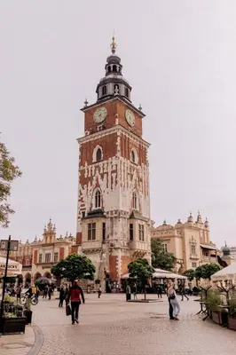 a tall tower with a clock on top of a building at Apartment in the Heart of Krakow - Between the Old Town and Kazimierz District in Kraków