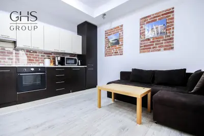 a living room with a couch and a table at Apartment in the Heart of Krakow - Between the Old Town and Kazimierz District in Kraków