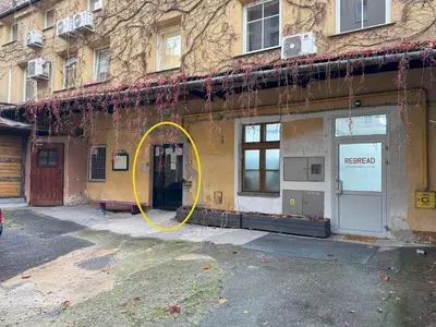 a building with a yellow circle in front of it at Dozen Kittens Apartment in Kraków