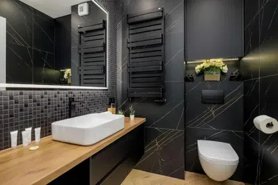 a black bathroom with a white sink and a toilet at Luksusowy, Klimatyzowany Apartament w Krakowie z Biurkiem i Parkingiem by Renters Prestige in Kraków