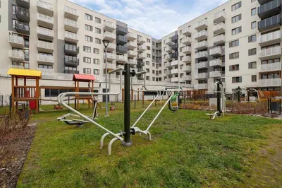 a playground in a park in front of a building at Luksusowy, Klimatyzowany Apartament w Krakowie z Biurkiem i Parkingiem by Renters Prestige in Kraków