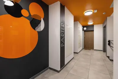 an office hallway with an orange and black wall at Luksusowy, Klimatyzowany Apartament w Krakowie z Biurkiem i Parkingiem by Renters Prestige in Kraków