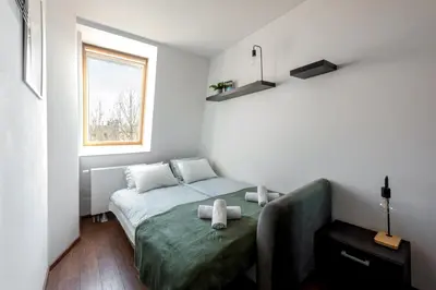 a bedroom with a bed with two stuffed animals on it at Charming Apartment with Air Conditioning for couples in the city center in Kraków