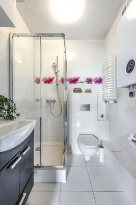 a white bathroom with a shower and a toilet at Charming Apartment with Air Conditioning for couples in the city center in Kraków