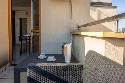 a table on a balcony with two cups and a blender at Charming Apartment with Air Conditioning for couples in the city center in Kraków