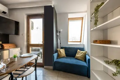 a living room with a blue chair and a table at Charming Apartment with Air Conditioning for couples in the city center in Kraków