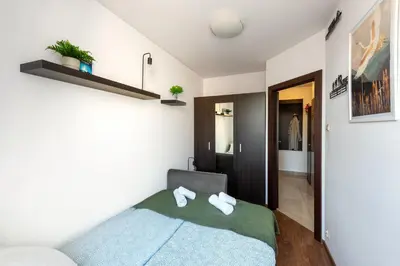 a bedroom with a bed with two towels on it at Charming Apartment with Air Conditioning for couples in the city center in Kraków
