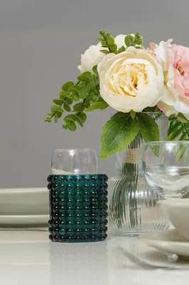 a vase with flowers in it on a table at Bright Apartment Near Old Town and Wawel by Noclegi Renters in Kraków