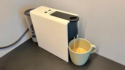 a coffee machine with a cup on a counter at RoseKrak in Kraków