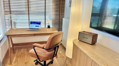 a desk with a laptop and a chair in a room at RoseKrak in Kraków