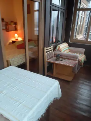 a room with a bed and a couch and a table at Willa Świt in Maków Podhalański