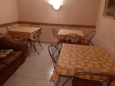 a dining room with tables and chairs and a couch at Willa Świt in Maków Podhalański