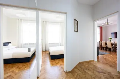 a hotel room with two beds and a mirror at Native Apartments Rajska 6 in Kraków