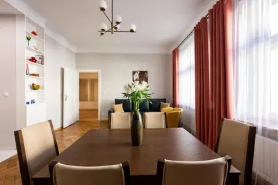 a dining room table with a vase of flowers on it at Native Apartments Rajska 6 in Kraków