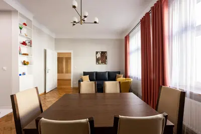 a dining room with a table and chairs at Native Apartments Rajska 6 in Kraków
