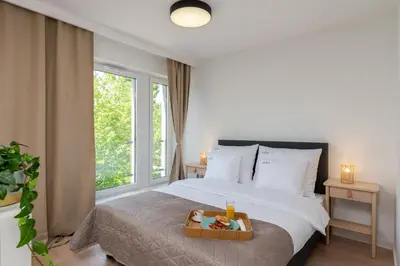 a bedroom with a bed with a tray of food on it at inQse Krakow Centre in Kraków