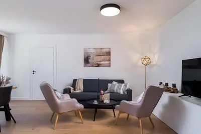 a living room with a couch and chairs and a table at inQse Krakow Centre in Kraków