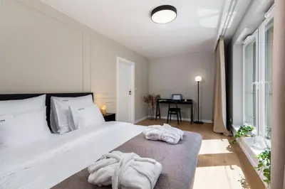 a bedroom with a large bed with towels on it at inQse Krakow Centre in Kraków
