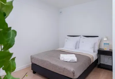 a bedroom with a bed with two towels on it at inQse Krakow Centre in Kraków