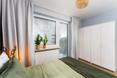 a bedroom with a bed and a window at Forest House by Cozyplace in Kraków