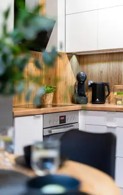 a kitchen with a stove with a coffee pot on it at Forest House by Cozyplace in Kraków