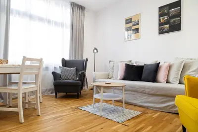 a living room with a couch and chairs and a table at Househost Apt Starowislna 75-2 in Kraków