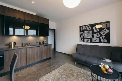 a living room with a couch and a table at inQse Krakow Brewery Residence in Kraków